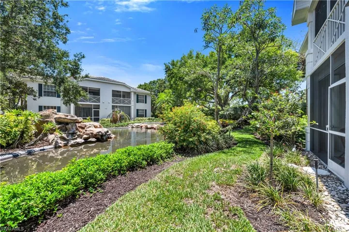 View of Yard featuring a Sunroom and a Garden Pond Water Feature