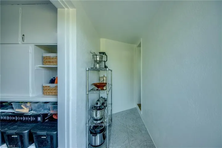 Hallway featuring tile floors