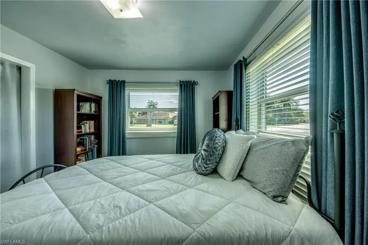 Bedroom with multiple windows