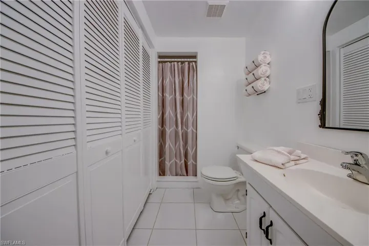 Bathroom featuring tile flooring, oversized vanity, and toilet