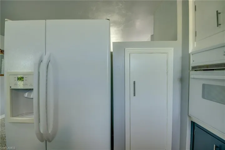Details featuring white cabinets and white appliances