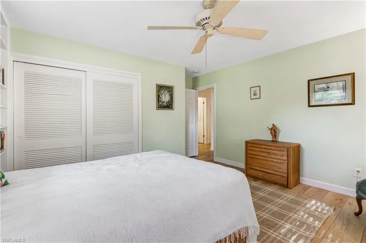 Bedroom featuring hardwood / wood-style floors, a closet, and ceiling fan