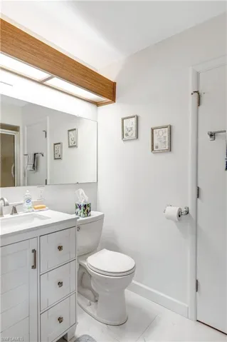 Full bath with vanity and a shower stall
