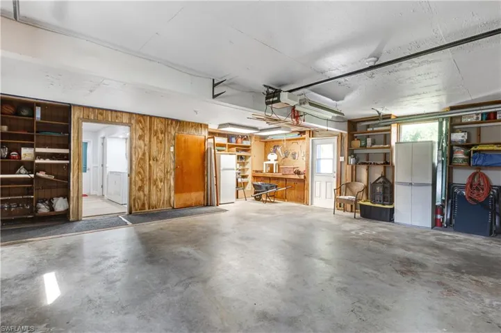 Garage featuring wooden walls and a garage door opener