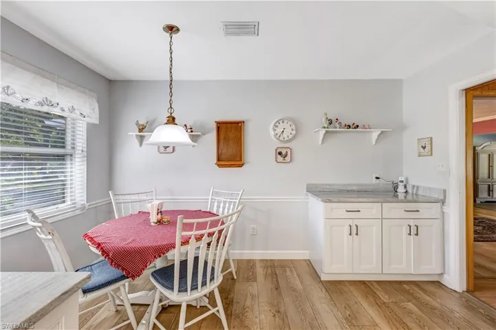 Dining space featuring light wood-style flooring and baseboards