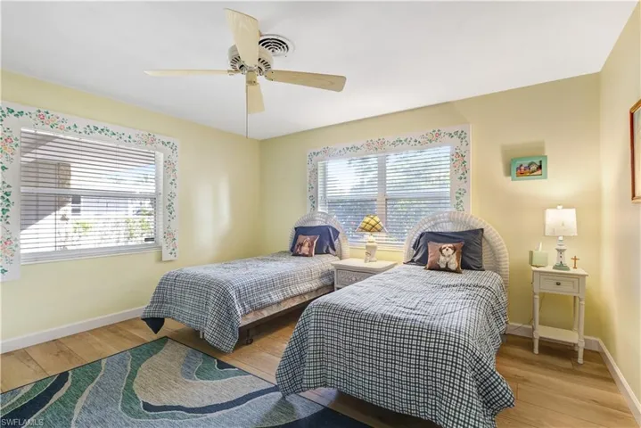 Bedroom with ceiling fan and light wood finished floors