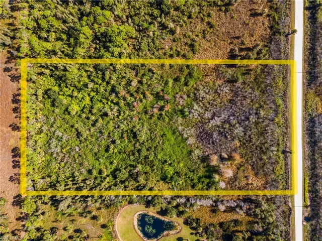 Aerial view of sparsely populated area featuring property boundaries highlighted