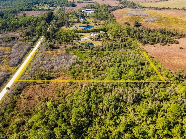 Aerial view of sparsely populated area featuring property boundaries highlighted
