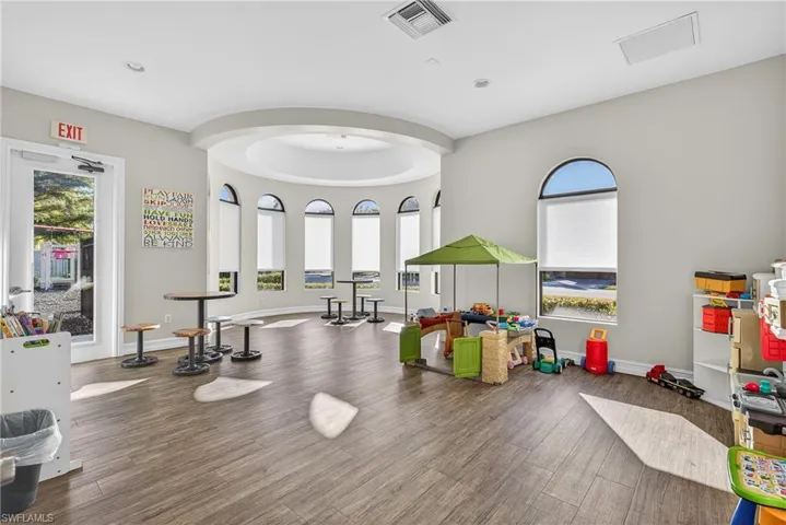 Amenity-rich Naples gated community of Andalucia featuring clubhouse, fitness center, social room, playroom, playground, and resort-style pool