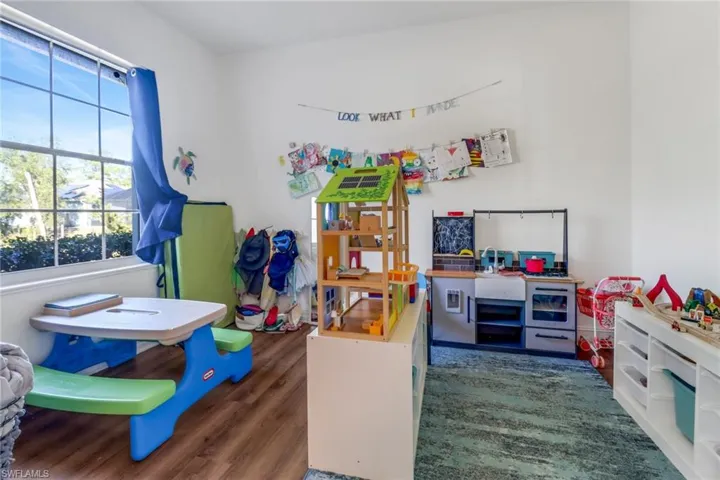 Recreation room featuring wood finished floors and a wealth of natural light