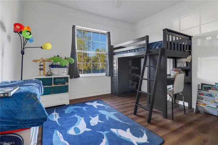 Bedroom featuring baseboards and wood finished floors