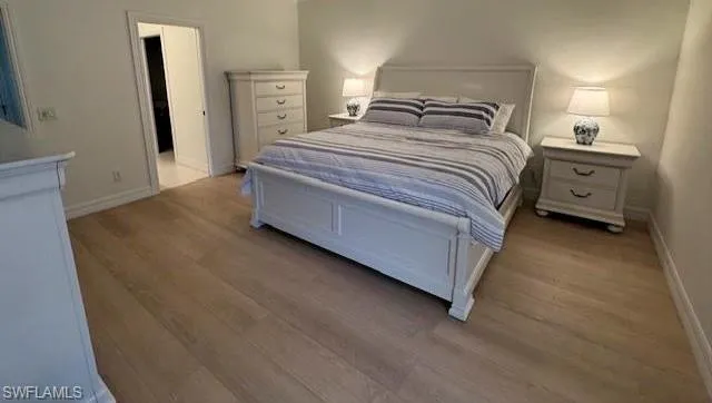 Master Bedroom with wood finished floors and baseboards
