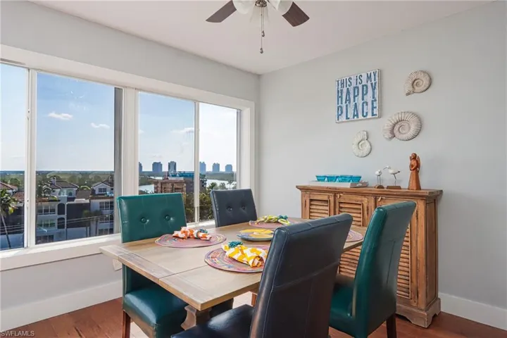 Dining room with ceiling fan and hardwood / wood-style floors