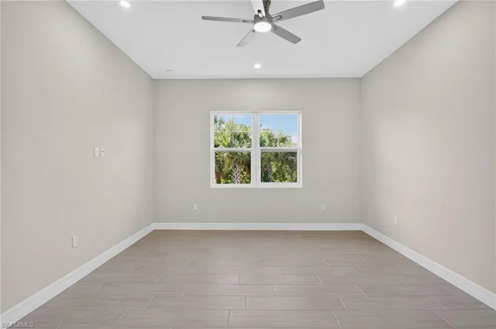 Spare room with ceiling fan, wood tiled floors, and recessed lighting