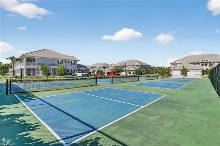 View of tennis court featuring a residential view
