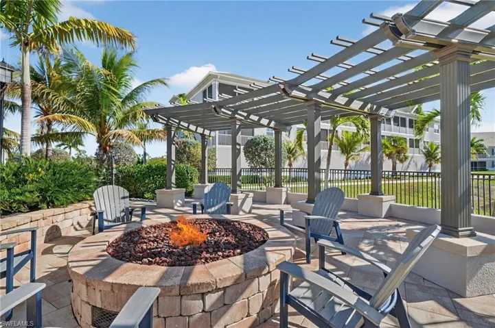 View of patio / terrace with an outdoor fire pit and a pergola