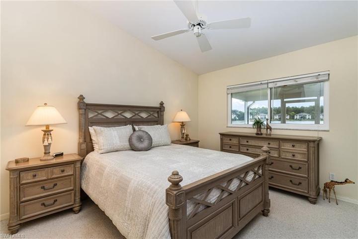 with queen bed and a lake view