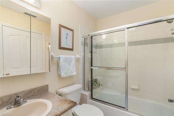 Guest bath with combo shower and tub with door to guest bedroom