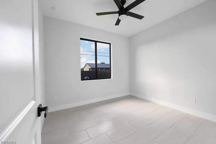 Empty room with baseboards and ceiling fan