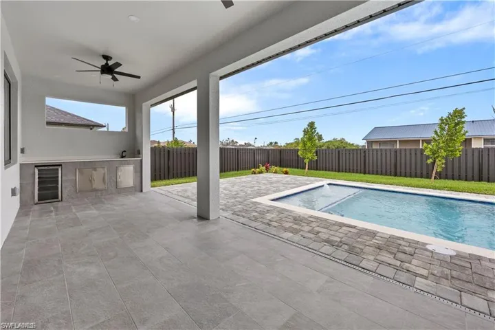 View of swimming pool featuring a patio, a ceiling fan, a fenced in pool, area for grilling, and a fenced backyard