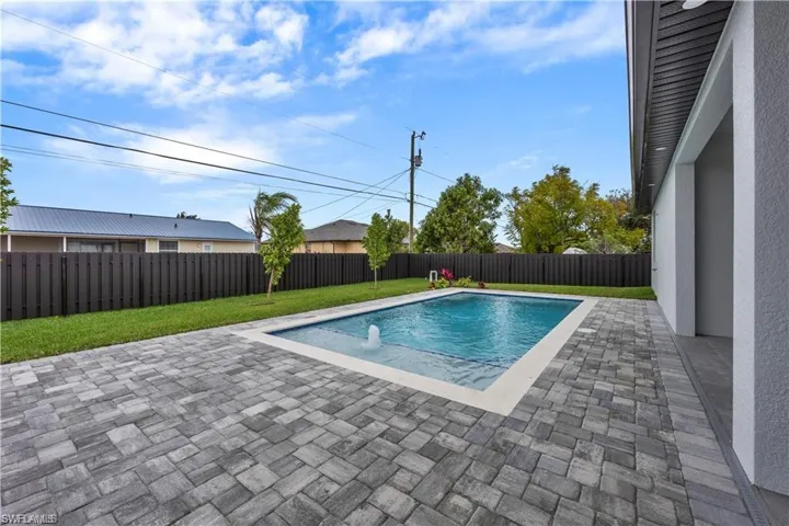 View of swimming pool with a fenced backyard, a patio area, a yard, and a fenced in pool