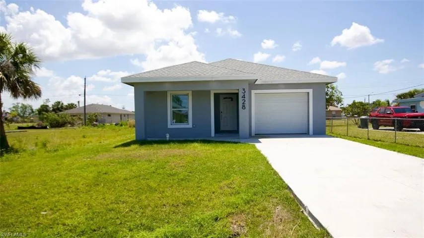 Contemporary single-story residence featuring a light gray exterior, white garage door, and a concrete driveway