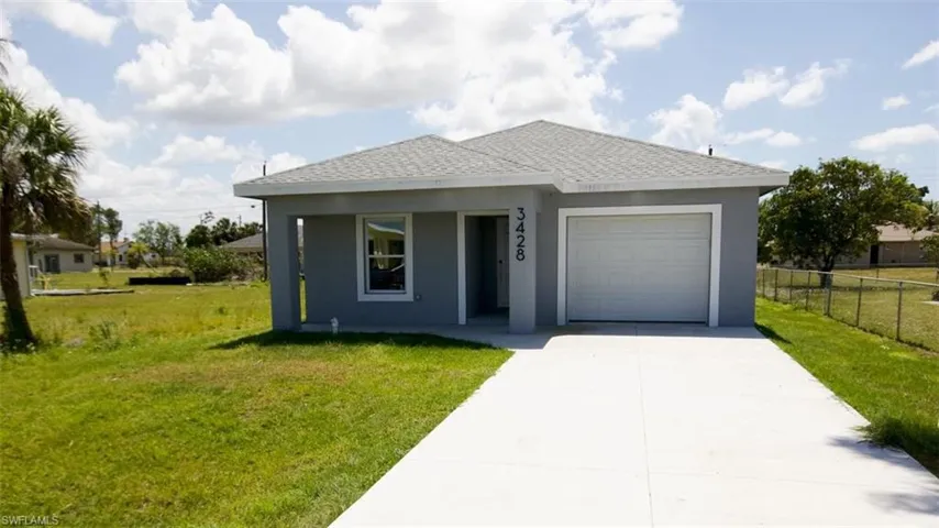 Contemporary single-story residence featuring a gray exterior finish, a gray shingle roof, an attached garage, and a concrete driveway
