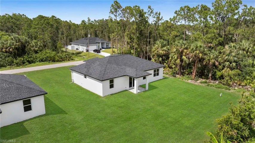 View from above of property featuring a heavily wooded area