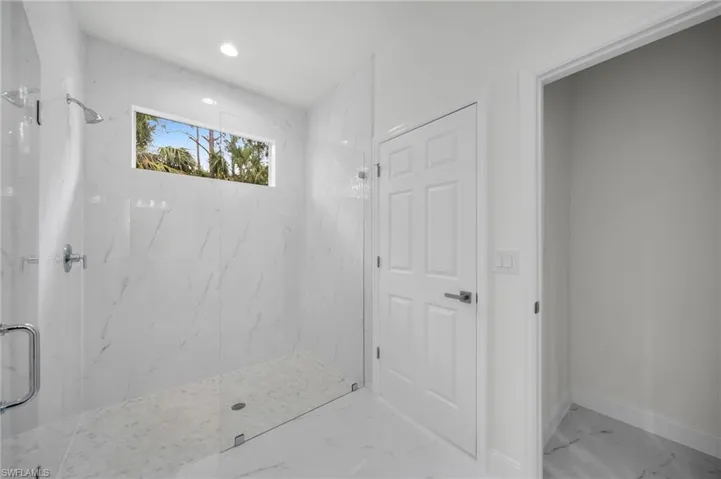 Full bathroom featuring a marble finish shower, marble finish flooring, and recessed lighting