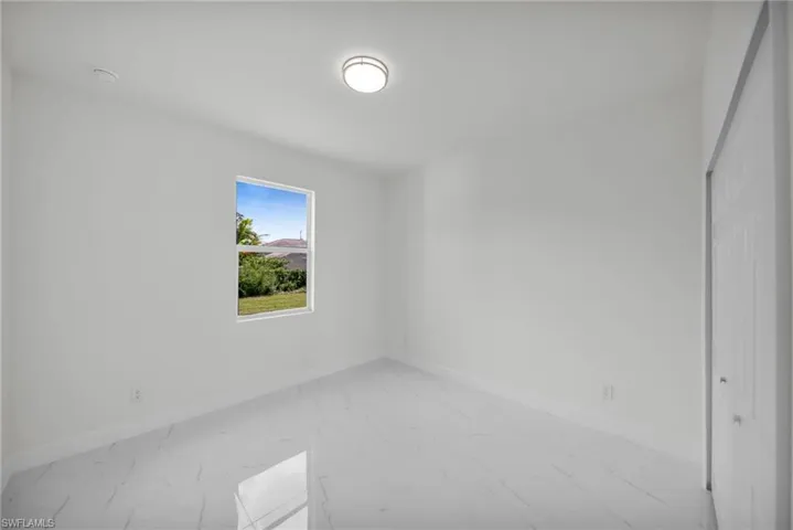 Empty room featuring light marble finish flooring