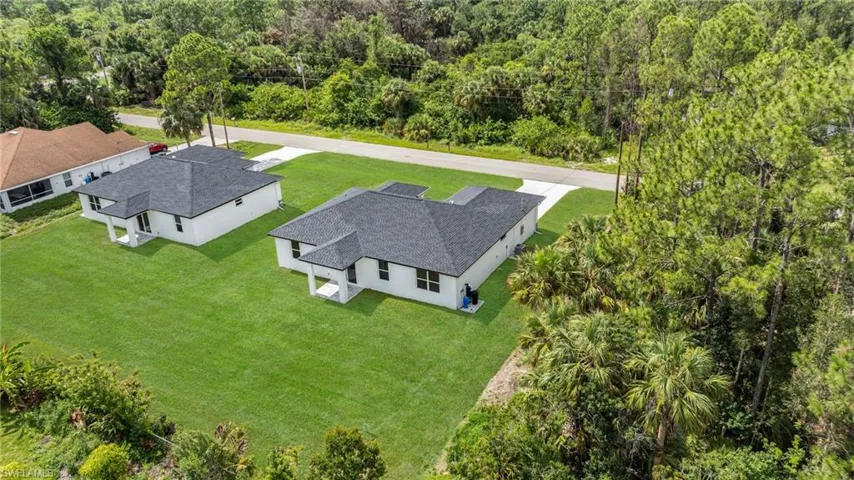 View from above of property featuring a heavily wooded area