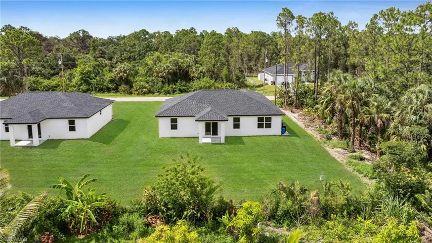 View of subject property with a forest
