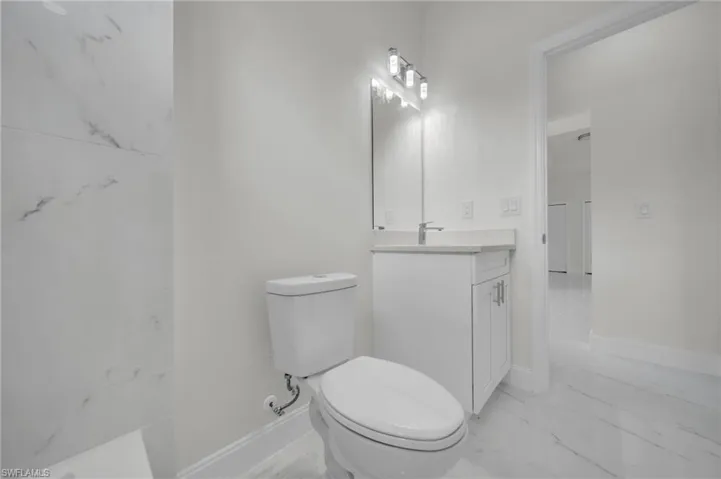 Bathroom with vanity and marble look tile flooring
