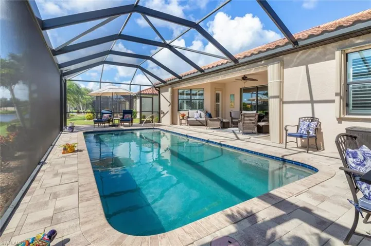 Outdoor pool with a ceiling fan, a patio area, a lanai, an outdoor living space, and a sunroom