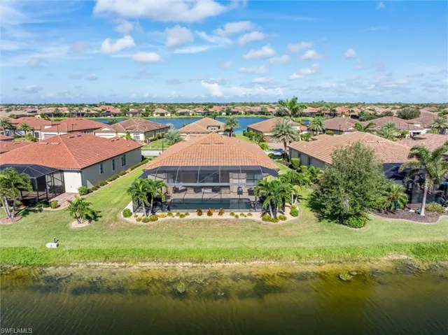 Aerial view of residential area featuring a nearby body of water