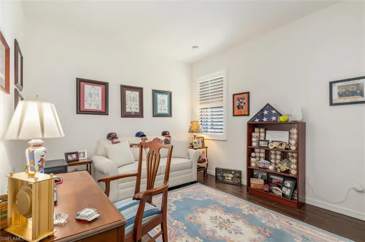 Home office with wood finish floors and baseboards