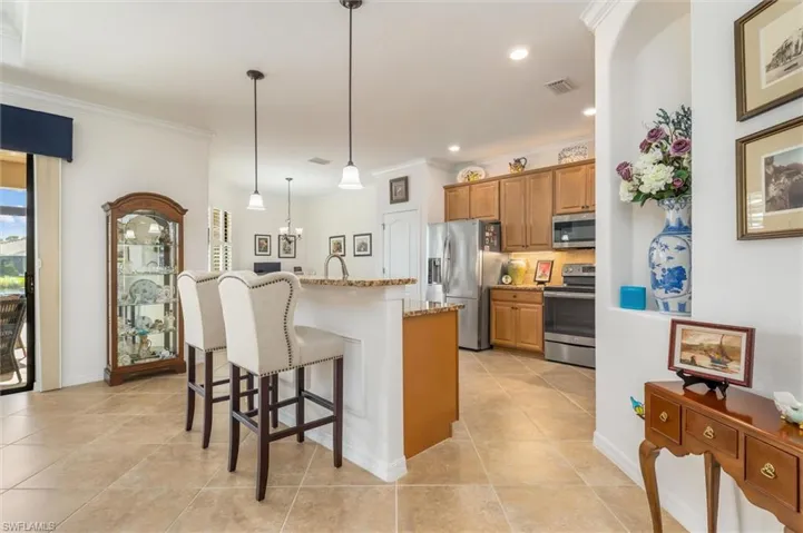 Chefs kitchen with wooden cabinets and granite countertops