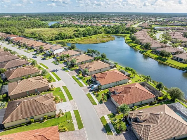 Aerial perspective of suburban area featuring a large body of water