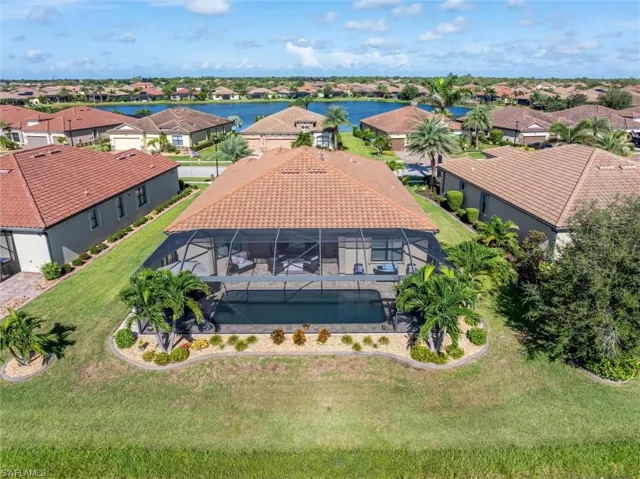 Aerial perspective of suburban area featuring a large body of water