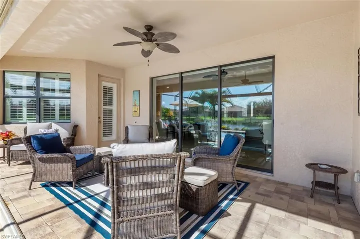 View of patio featuring an outdoor hangout area, a ceiling fan, and a water view