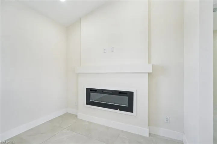 Detailed view of a glass covered fireplace and recessed lighting