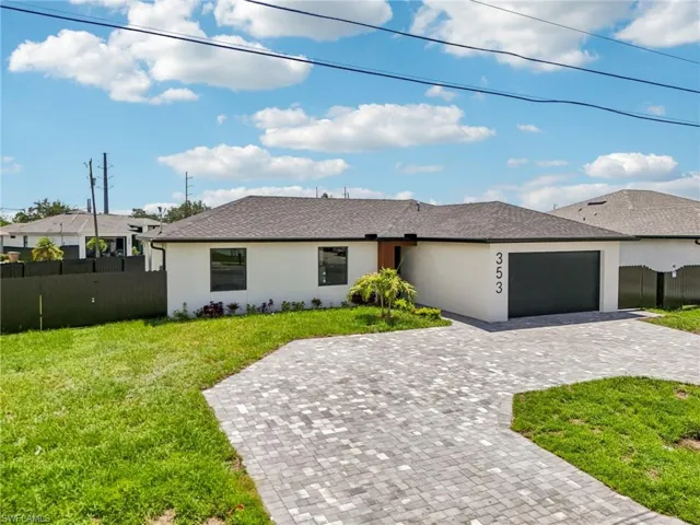 Ranch-style house featuring an attached garage, stucco siding, decorative driveway, and a shingled roof