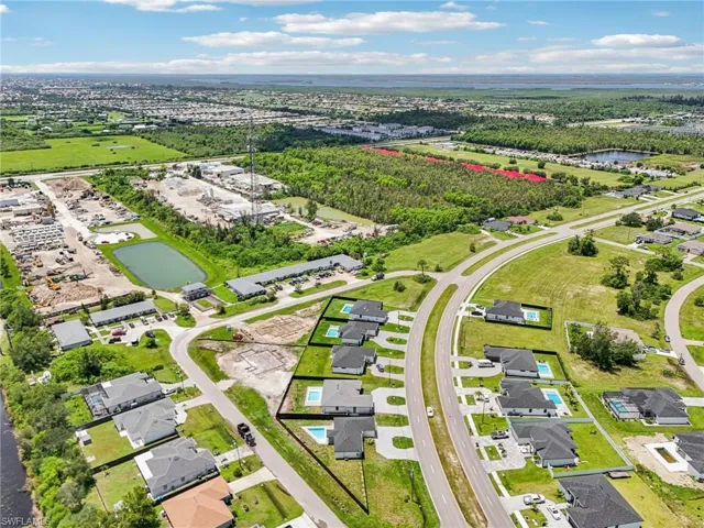 Aerial view of residential area featuring a large body of water
