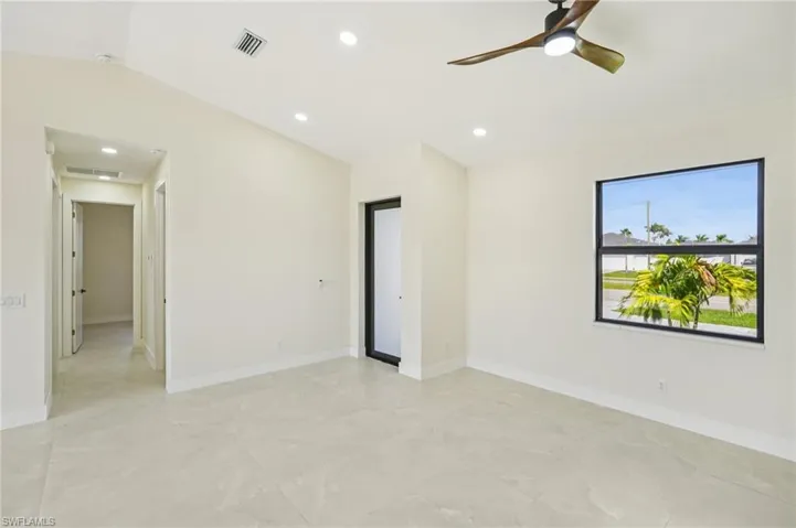 Empty room with lofted ceiling, recessed lighting, and ceiling fan