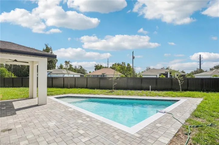 View of swimming pool featuring a fenced backyard and a patio area