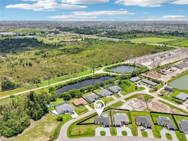 Aerial overview of property's location featuring a nearby body of water and nearby suburban area