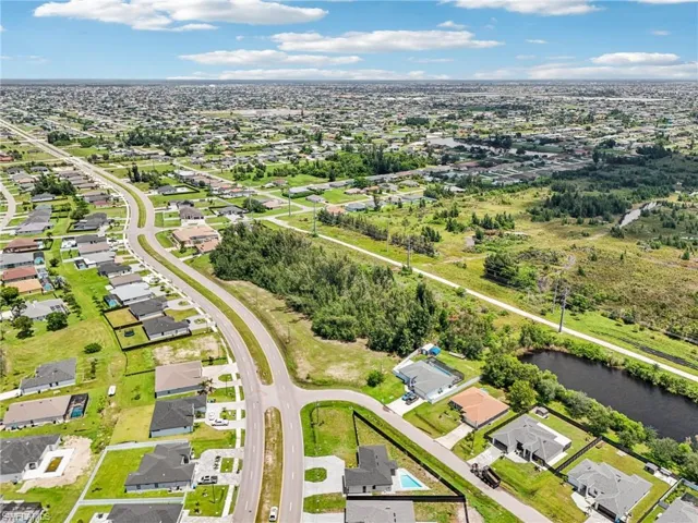 Aerial view of property's location with nearby suburban area