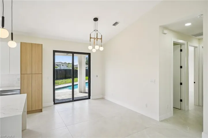 Unfurnished dining area with a chandelier, light tile patterned flooring, and recessed lighting