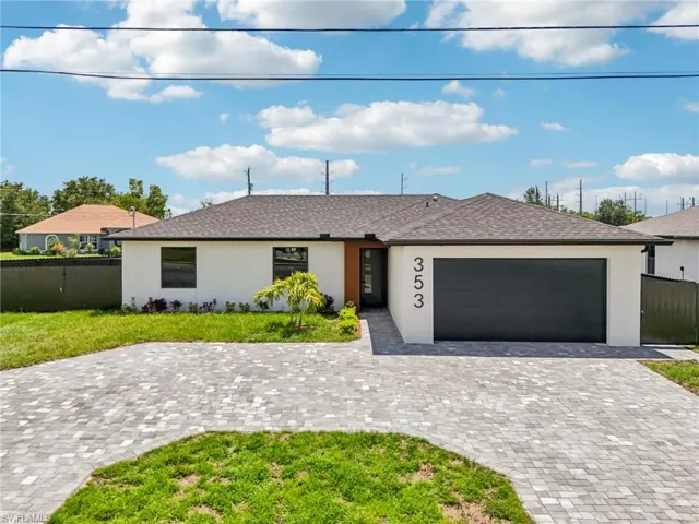 Ranch-style home with stucco siding, a garage, decorative driveway, and a shingled roof