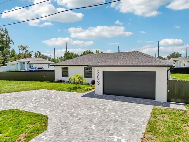 View of front of home featuring stucco siding, decorative driveway, an attached garage, and roof with shingles